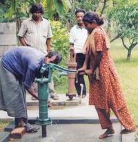 Low cost shallow well (green) with arsenic free sweet water close to the DPHE constructed deep tube well - saline and iron rich water at Noakhali- May 2004.